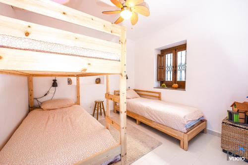 a bedroom with two bunk beds and a window at The Blue House in La Herradura