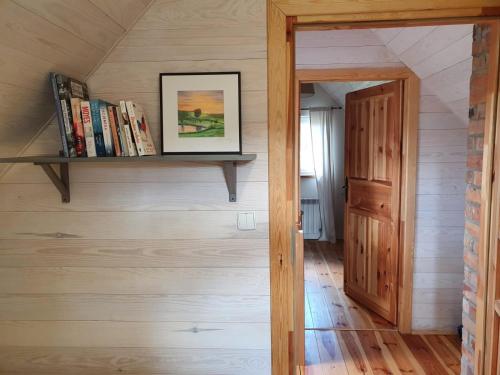 a staircase in a tiny house with a book shelf at Kartkówka in Unichowo
