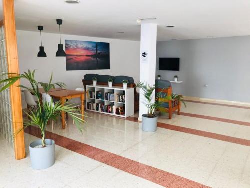 a lobby with potted plants in a building at Apartamentos Europa, Playa del Inglés in Playa del Ingles