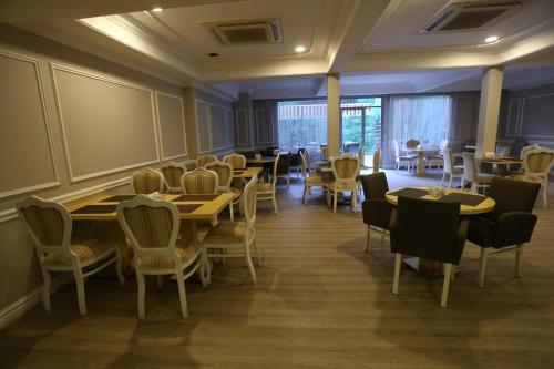a restaurant with tables and chairs in a room at Albatros Premier Hotel in Istanbul