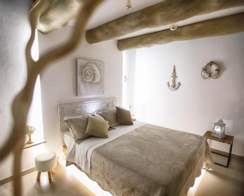 a bedroom with a bed in a white room at b&b le onde praiola in Terrasini