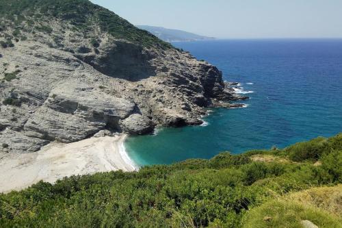 an aerial view of a beach on a cliff at Villa Rokanes Glass Stone with Pool in Kouvéllai