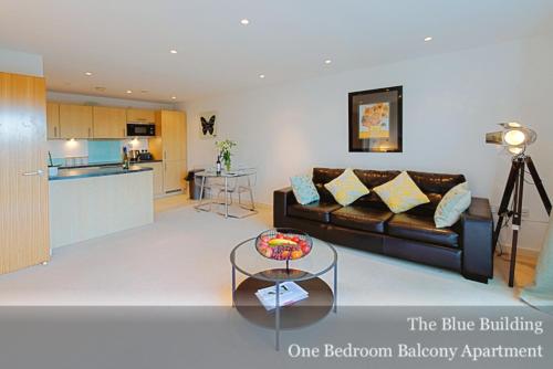 a living room with a couch and a table at Gunwharf Quays Apartments in Portsmouth
