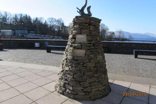 a stone wall with a statue on top of it at Craiglynn Holiday Apartment Loch Lomond in Balloch
