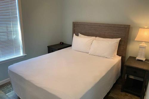 a bedroom with a large white bed with two night stands at Cozy Tiny Home Near Disney World & Orlando Parks! in Kissimmee