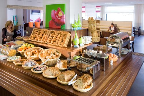 
a table topped with lots of different types of food at ibis Antwerpen Centrum in Antwerp

