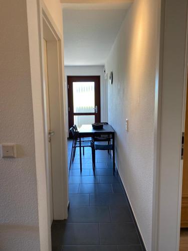 a hallway with a table and a dining room at Ferienhof Kröger in Bielefeld