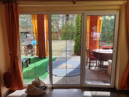 a sliding glass door with a view of a patio at Zielony Domek - Tleń Bory Tucholskie in Tleń
