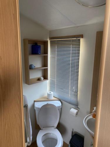 a small bathroom with a toilet and a sink at Nicks & Carmels by the sea in Heysham
