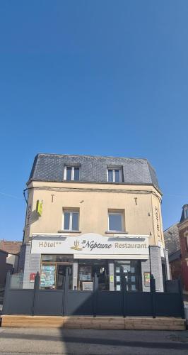 a building on the corner of a street at Logis - Le Neptune Hôtel & Restaurant in Cayeux-sur-Mer