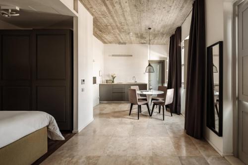 a bedroom with a bed and a table and chairs at 19 ROOMS in Valletta