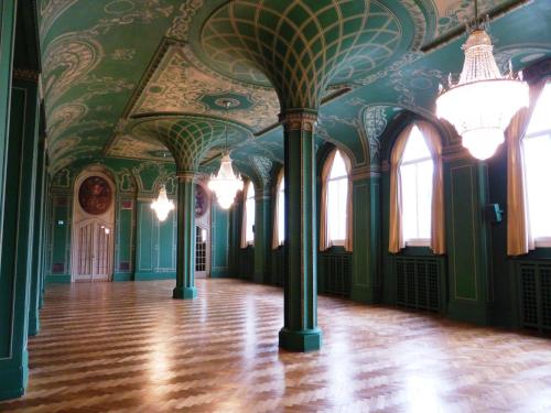 a room with green walls and ceilings with a wooden floor at Hotel Bayerischer Hof in Bad Kissingen