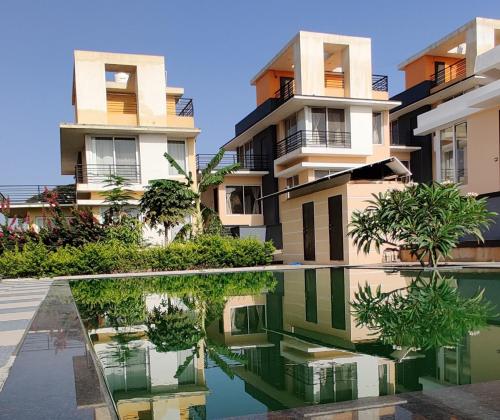 an image of a building with a reflection in a pool at ROYAL MEADOWS - IGATPURI Bungalow C in Igatpuri
