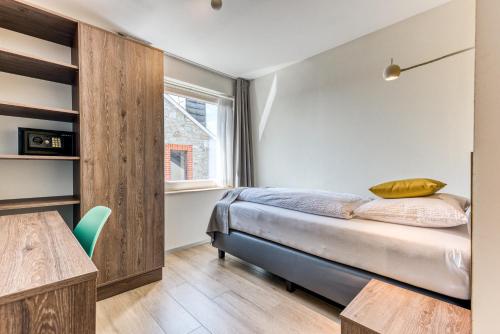 Кровать или кровати в номере HOTEL L'AVENUE