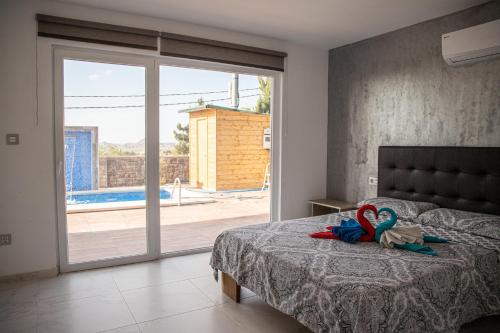a bedroom with a bed and a sliding glass door at MountainBeach in San Vicente del Raspeig