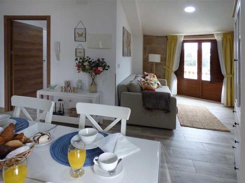 a kitchen and living room with a table and chairs at CASA VEIGA in Pontevedra