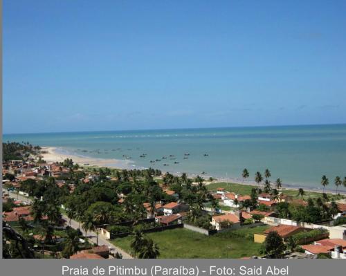 a group of birds flying over a beach at Casa de Praia Pitimbu in Pitimbu