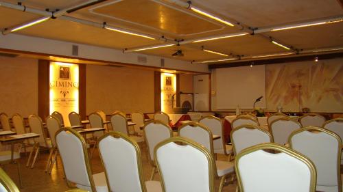 a conference room with tables and chairs and a screen at Hotel Vienna Ostenda e Ristorante il Danubio in Rimini