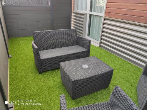 a patio with two chairs and a table at Atao Residence- Rennes Sud in Vern-sur-Seiche