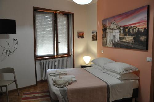 a bedroom with a bed and a picture on the wall at CityWalls Guest House Bergamo in Bergamo