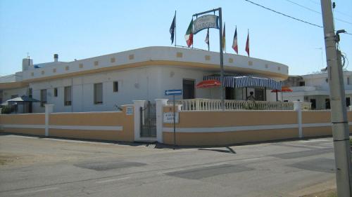 a building with flags on top of it at Albergo Europa in Marina di Mancaversa