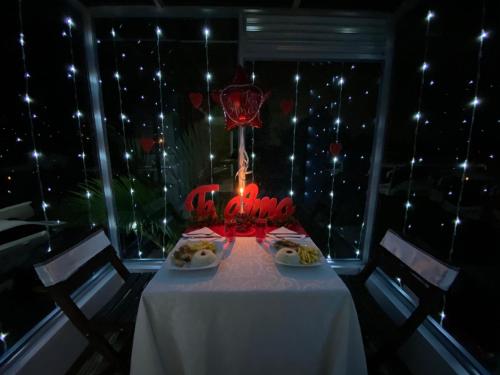 a table with a candle in a room with lights at Hotel Las Palmeras Gachancipa in Gachancipá
