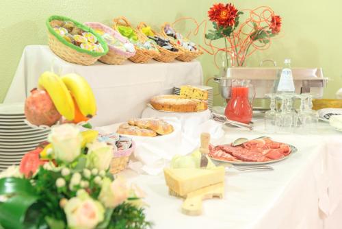 a table with a buffet of food on it at Hotel San Pietro in Assisi