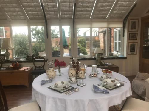 a table in a living room with a white table cloth at The Gardens in Daventry