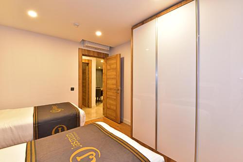 a hotel room with a bed and a sliding glass door at Jasmin Elite Residence & SPA in Gümbet