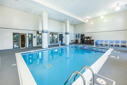 a large swimming pool with blue water in a building at Hyatt House Chicago Schaumburg in Schaumburg