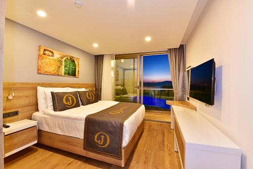 a hotel room with a bed and a large window at Jasmin Elite Residence & SPA in Gümbet