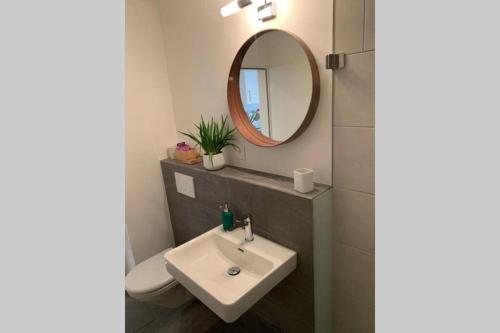 a bathroom with a sink and a mirror at Studio neben Therme für 2 Erwachsene neu renoviert in Vals