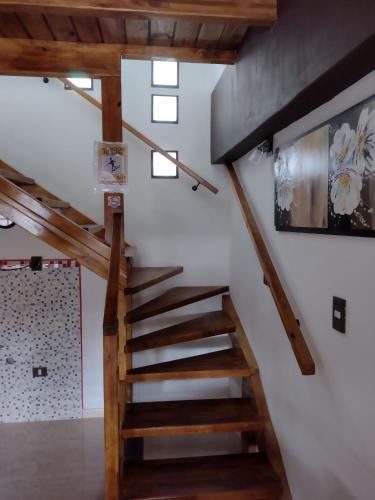 a staircase in a house with wooden ceilings at MALARGUE STYLE,A 100 Mtrs DEL CENTRO,MUY UBICADO in Malargüe