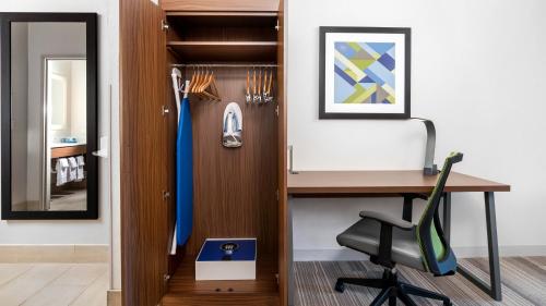 an office with a desk and a chair next to a table at Holiday Inn Express Hotel and Suites Conroe, an IHG Hotel in Conroe