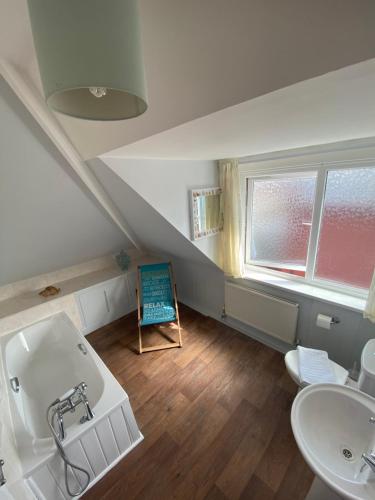 a bathroom with a sink and a bath tub at The Bayridge Guest House in Bridlington