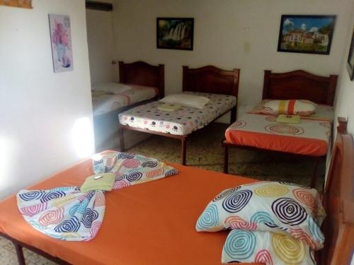 a room with two twin beds and two tables at Hotel Andaluz in Andalucía