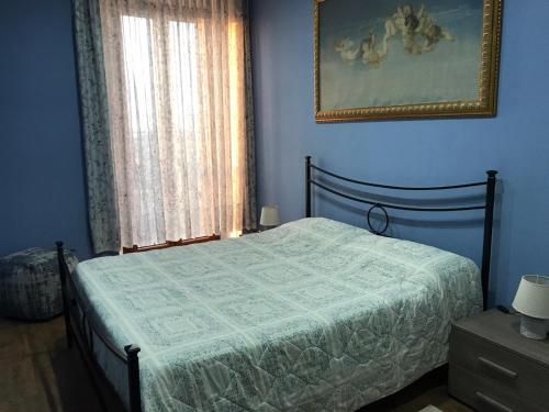 a bedroom with a bed in a blue room at Civico 78 in Montefiascone