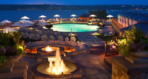 a swimming pool with a fire pit in a resort at Wequassett Resort and Golf Club in East Harwich