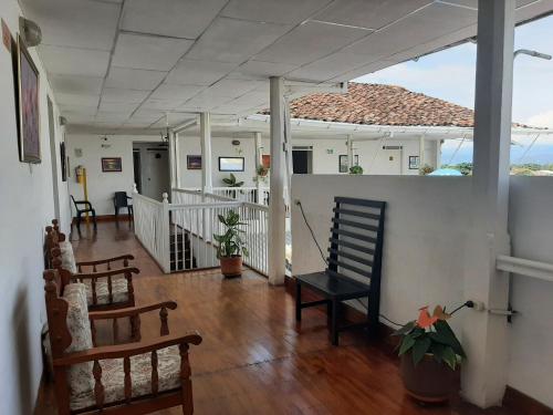 a living room with a porch with a rocking chair at Hotel Andaluz in Andalucía