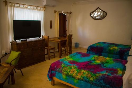 A bed or beds in a room at La Quinta Orquídea