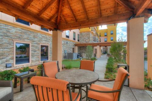 an outdoor patio with a table and chairs at Staybridge Suites Lubbock South by IHG in Lubbock