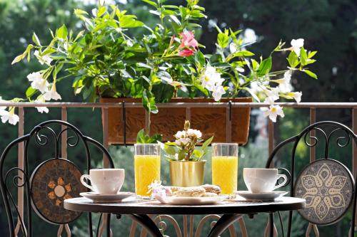 una mesa con vasos de zumo de naranja y flores en ella en Villa Lina, en Pula