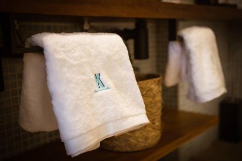 a towel with the letter k on it on a shelf at K-SPACE by Nuka Homes in Jávea