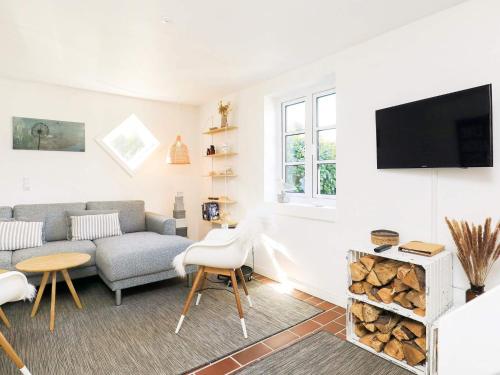 a living room with a couch and a tv at 4 person holiday home in Skagen in Skagen