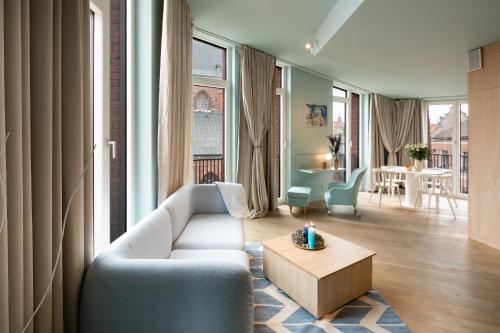 a living room with a couch and a table at Redstone Apartments in Riga