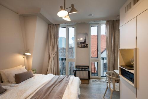 a bedroom with a bed and a window with a view at Redstone Apartments in Rīga
