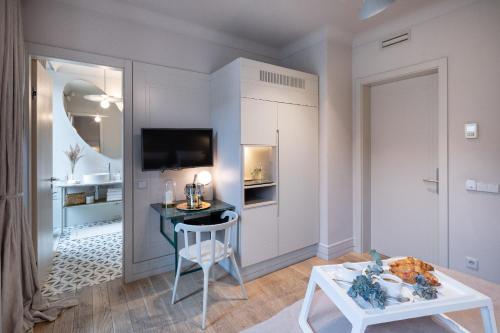 a living room with a table and a chair at Redstone Apartments in Rīga