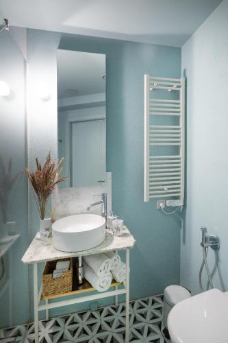 a bathroom with a sink and a mirror at Redstone Apartments in Rīga