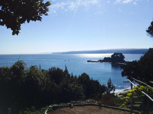 a view of the ocean from a bluff at Alojha Coliumo Dichato in Coliumo