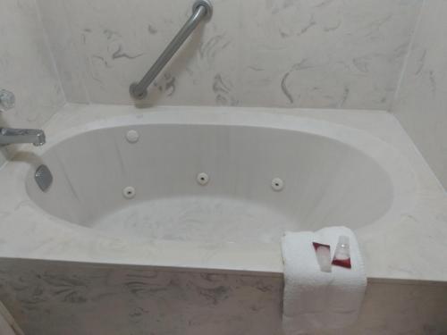 a bath tub with a roll of toilet paper in a bathroom at America's Best Value Inn Clarksdale in Clarksdale